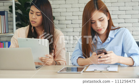 Happy success business woman partner working together in company office corporate executive teamwork. Meeting Executive Asian business woman using laptop office desk with fist arm raised win happiness 111256475