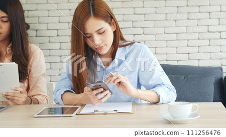 Happy success business woman partner working together in company office corporate executive teamwork. Meeting Executive Asian business woman using laptop office desk with fist arm raised win happiness 111256476