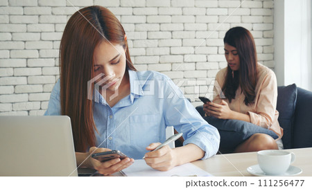 Happy success business woman partner working together in company office corporate executive teamwork. Meeting Executive Asian business woman using laptop office desk with fist arm raised win happiness 111256477