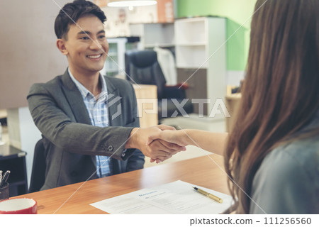 Job HR applicants having an interview with Human resource manager jobs interviewing with confident candidate at business firm office give cv resume. Job Interview with headhunter agent and applicant 111256560