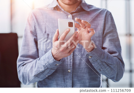 close up.a businessman uses a smartphone. people and technology 111256709