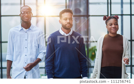 Successful african american business team standing with arms crossed in the office Successful african american business team standing with arms crossed in the office 111256741
