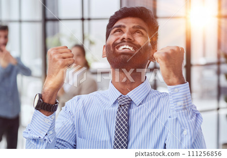 a man holding his hand up a gesture of triumph and victory. a man holding his hand up a gesture of triumph and victory. 111256856