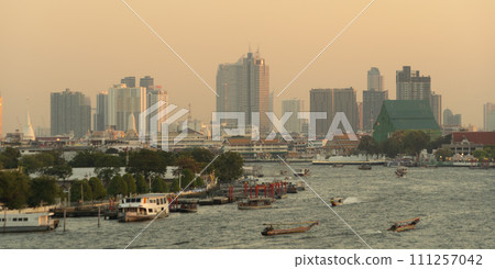 Aerial view of Bangkok Downtown Skyline with Chao Phraya River, Thailand. Financial district and business centers in smart urban city in Asia. Skyscraper and high-rise buildings. Aerial view of Bangkok Downtown Skyline with Chao Phraya River, Thailand. Financial district and business centers in smart urban city in Asia. Skyscraper and high-rise buildings. 111257042