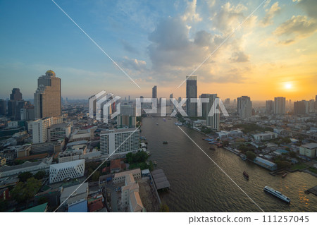 Aerial view of Bangkok Downtown Skyline with Chao Phraya River, Thailand. Financial district and business centers in smart urban city in Asia. Skyscraper and high-rise buildings. Aerial view of Bangkok Downtown Skyline with Chao Phraya River, Thailand. Financial district and business centers in smart urban city in Asia. Skyscraper and high-rise buildings. 111257045