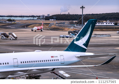 Chiba cityscape in Japan, looking at Cathay Pacific and other airlines from Narita Airport 2. Passenger planes one after another... 111257565