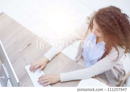 Successful female grapic designer watching tutorial about creative ideas at laptop 111257947