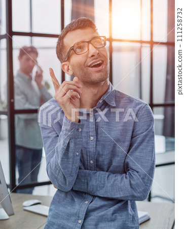 a man raised his finger up, came up with an idea how to make money, vertical shot 111258732