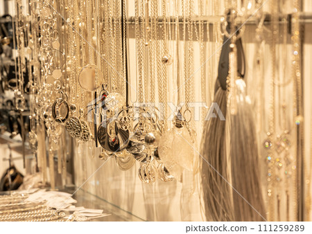 blurred gold jewelry necklace chains for background, panel gold shop jewelry store for seller products and gold showcase 111259289