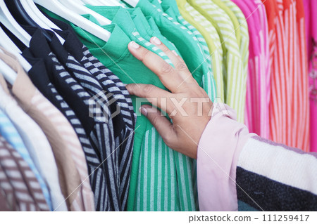 woman choosing clothes in shop. woman choosing clothes in shop. 111259417
