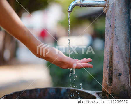 Antalyas old town: female hand gracefully reaches for drinking fountain, refreshing oasis amidst historical charm, offering sip of history and tranquility Antalyas old town: female hand gracefully reaches for drinking fountain, refreshing oasis amidst historical charm, offering sip of history and tranquility 111259692