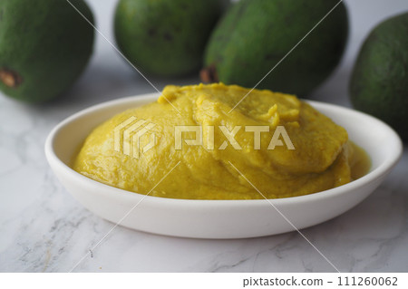 avocado and avocado pasted in a container 111260062