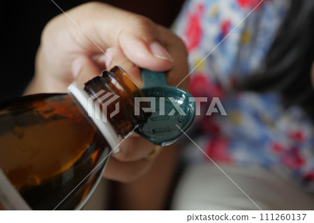 A dose of cough syrup. 111260137