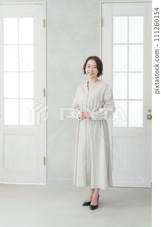Smiling middle-aged woman whole body Smiling middle-aged woman whole body 111260154