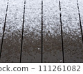 Snow piled up on the wooden deck 111261082