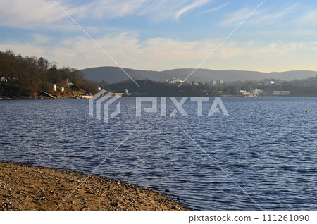 Brno Reservoir - City of Brno - Czech Republic - Europe. Beautiful landscape with water and beach. Nice sunny weather with blue sky in winter time. Brno Reservoir - City of Brno - Czech Republic - Europe. Beautiful landscape with water and beach. Nice sunny weather with blue sky in winter time. 111261090
