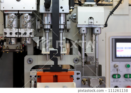 close up of plastic injection blow molding machine 111261138