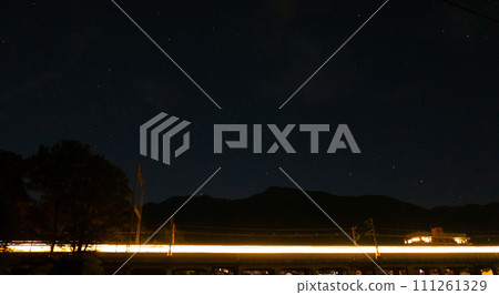 Freight train passing under the starry sky 111261329