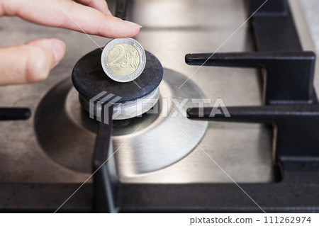 The cost of gas, the euro crisis. a euro coin on the background of a gas burner. 111262974