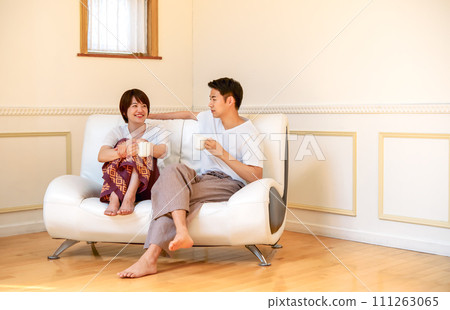 A relaxing couple in the living room A relaxing couple in the living room 111263065