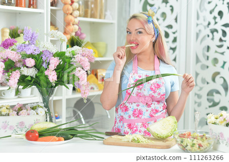 Young woman cooking healthy food in kitchen 111263266