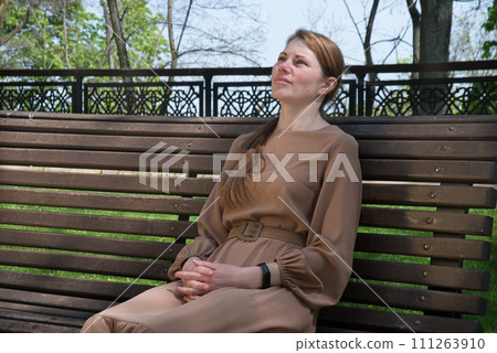 Pretty girl sitting on the bench 111263910
