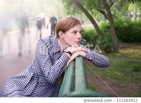 Pretty girl sitting on the bench 111263912