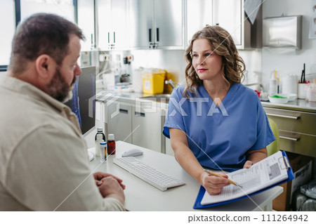 Doctor consulting with overweight patient, discussing test result in doctor office. Concept of health risks of overwight and obesity. 111264942