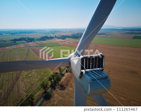 Aerial view of wind turbine in countryside area, Wind power plants in agricultural landscape, Green energy from renewable sources concept Aerial view of wind turbine in countryside area, Wind power plants in agricultural landscape, Green energy from renewable sources concept 111265467