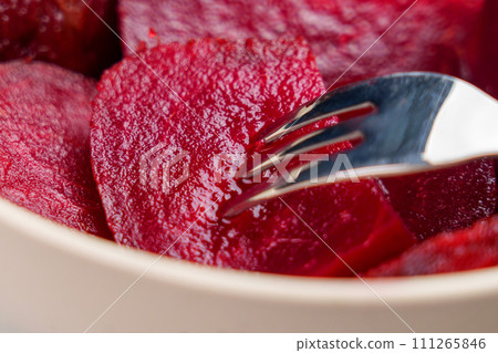 Eating fresh boiled red beets with a fork. Macro shot. Healthy eating concept 111265846