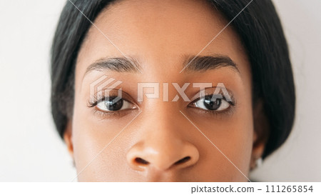Eyes health. Vision correction. Sight clinic. Ophthalmology services. Young beautiful calm woman face portrait isolated on white background. 111265854