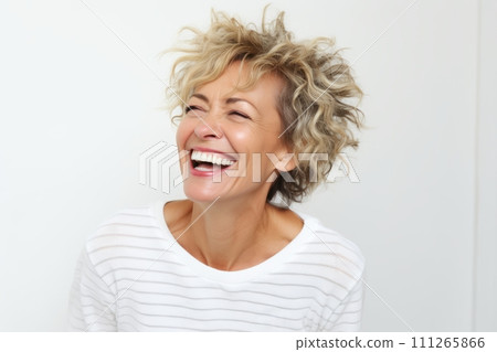 Happy middle-aged woman laughing and looking up on white background 111265866