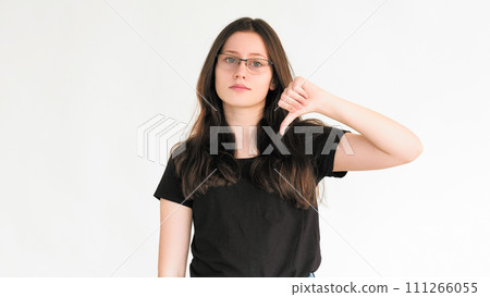 Dislike sign. Bad feedback. Reject no. Negative disapproval. Skeptic woman refusing with thumb down hand gesture isolated on white empty space background. Dislike sign. Bad feedback. Reject no. Negative disapproval. Skeptic woman refusing with thumb down hand gesture isolated on white empty space background. 111266055