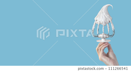 Confectionery concept. Whisk for mixer with cream blue background 111266541