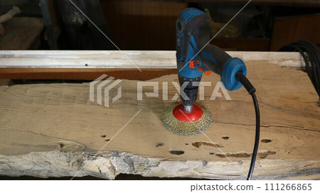 screwdriver with a round nozzle with metal bristles for processing the surface of wood in the production of products from wooden materials, a carpenter's tool for smoothing out unevenness in wood screwdriver with a round nozzle with metal bristles for processing the surface of wood in the production of products from wooden materials, a carpenter's tool for smoothing out unevenness in wood 111266865
