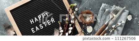 Happy Easter letter board and spring table setting top view 111267506
