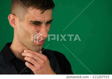 Middle aged sick man having sore throat, looking at copy space over grey studio background. Bearded man touching his red neck, suffering from throat disorder, tonsillitis, throat cancer, cold Middle aged sick man having sore throat, looking at copy space over grey studio background. Bearded man touching his red neck, suffering from throat disorder, tonsillitis, throat cancer, cold 111267555