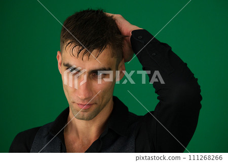 Sad Young Man Portrait on The green Background Sad Young Man Portrait on The green Background 111268266