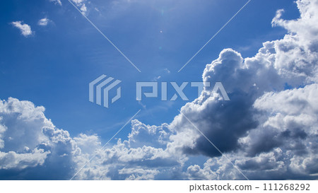 Cumulonimbus clouds appearing in the blue sky 111268292