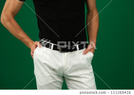 A man's hand in the pocket of brown stylish pants close-up on a white background. Successful young man, businessman, entrepreneur in an expensive business A man's hand in the pocket of brown stylish pants close-up on a white background. Successful young man, businessman, entrepreneur in an expensive business 111268416