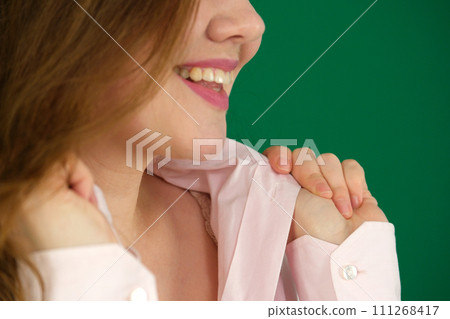 Young woman wearing white shirt holding collar up. Young woman wearing white shirt holding collar up. 111268417