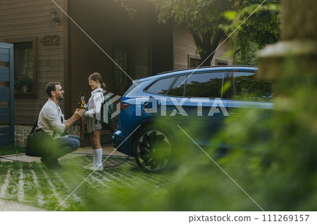 Father handing girl her science project for school science fair, robotic arm. Electric car is charging before going to school and work. Concept of young girls in science. 111269157