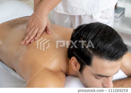 Caucasian man customer enjoying relaxing anti-stress massage. Quiescent 111269259