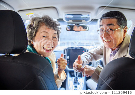 Senior couple drive thumbs up 111269416
