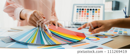 Interior designer choose appropriate color from color palette. Variegated Interior designer choose appropriate color from color palette. Variegated 111269419