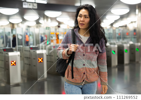Asian woman passing through ticket gates in public transportation station 111269552