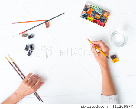 Top view of girl's hands drawing Top view of girl's hands drawing 111269877