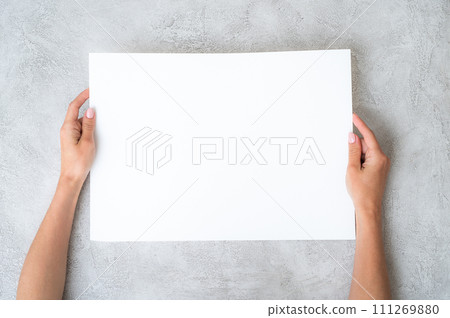 Girl's holding a paper Girl's holding a paper 111269880