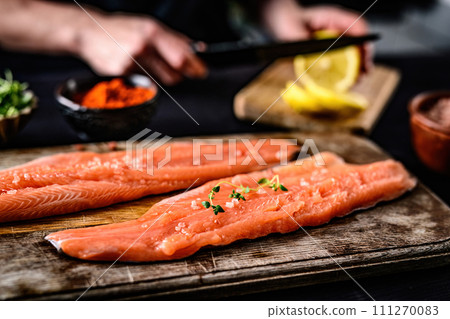 cooking fresh red fish trout fillet on a cutting board 111270083