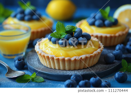 Lemon tarts decorated with blueberries spoons. Lemon tarts decorated with blueberries spoons. 111270444